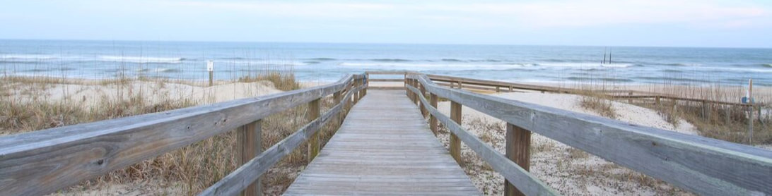 A walkway on a journey away from anxiety and depression toward a calm, relaxing beach and ocean.
